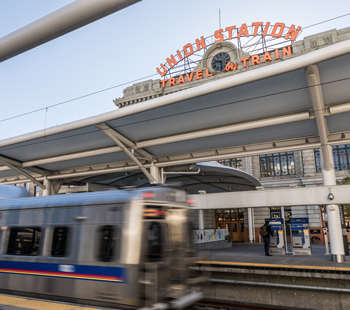action shot of RTD train arriving outside of Union Station in downtown Denver