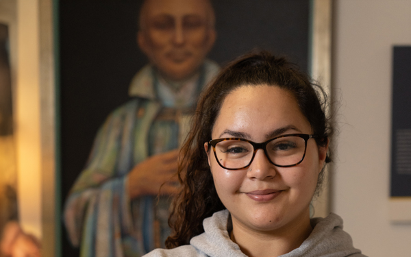 Regis University student standing confidently indoors