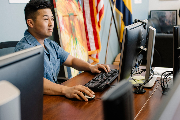 man on computer in resource center