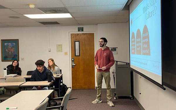 a Regis University violence prevention educator hosting a educational talk