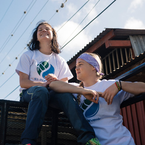 Regis University students relaxing outdoors during a service trip in Nicaragua.