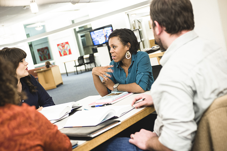 woman in office talking to group