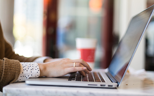 Woman types at computer