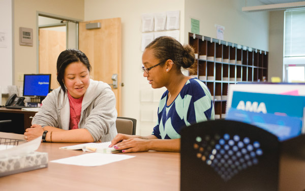 two people at table in writing center