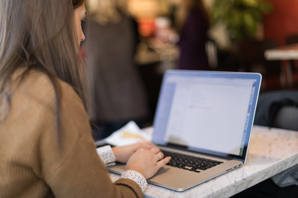 Recent college graduate uses her laptop to prepare for her job search