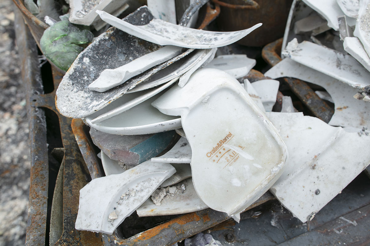 broken dishes among the debris of Dino's home