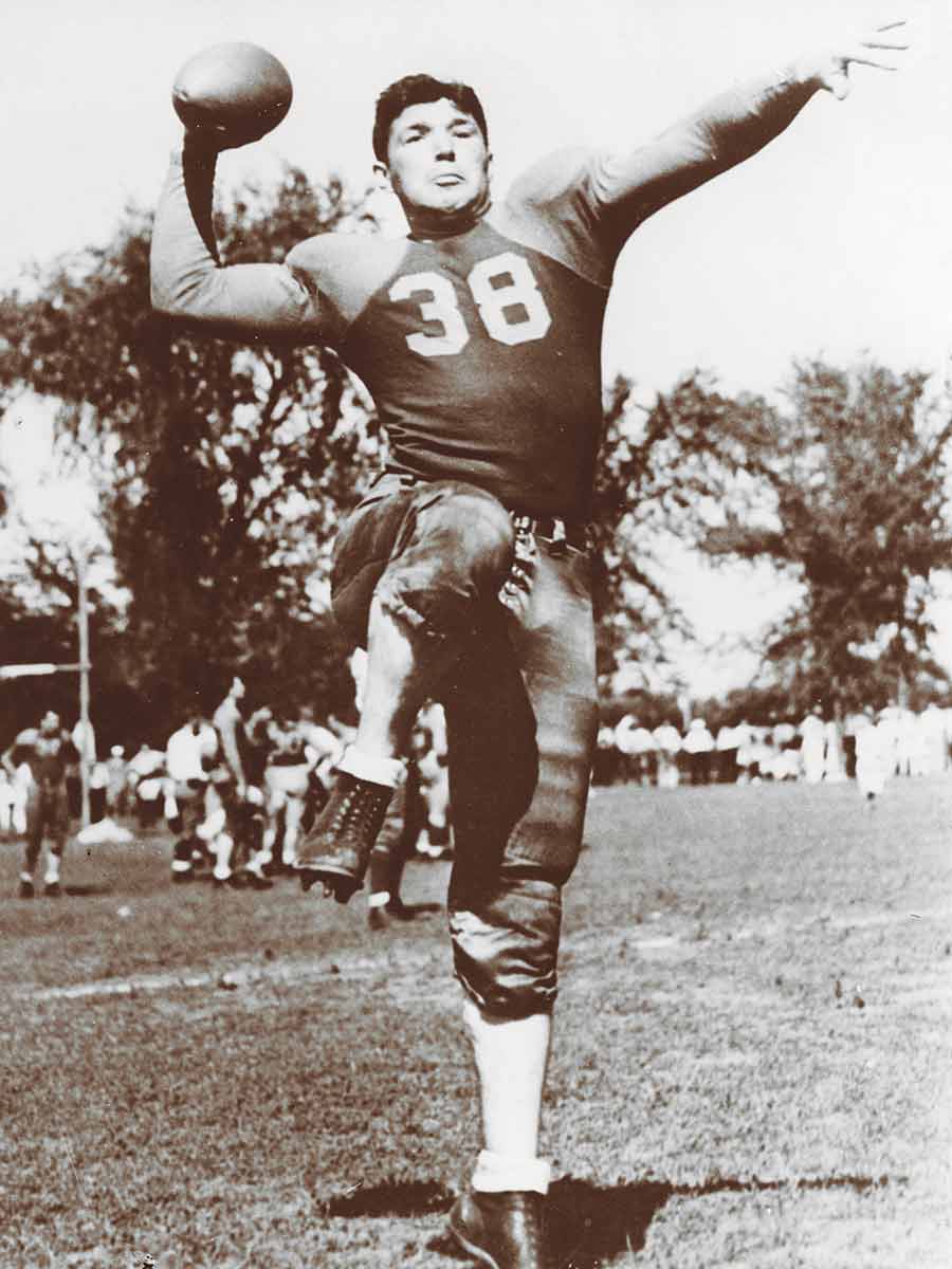 Arnie Herber about to throw an American football