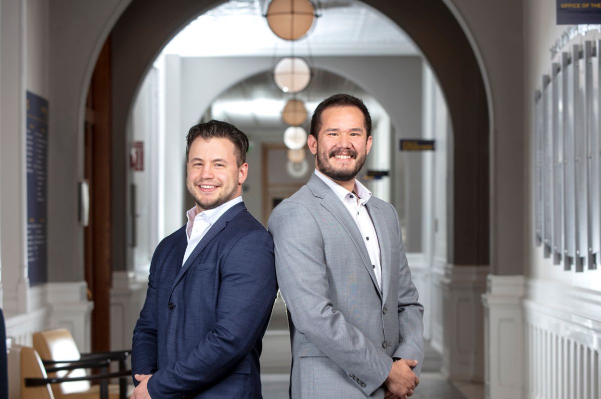 two men in suits smiling