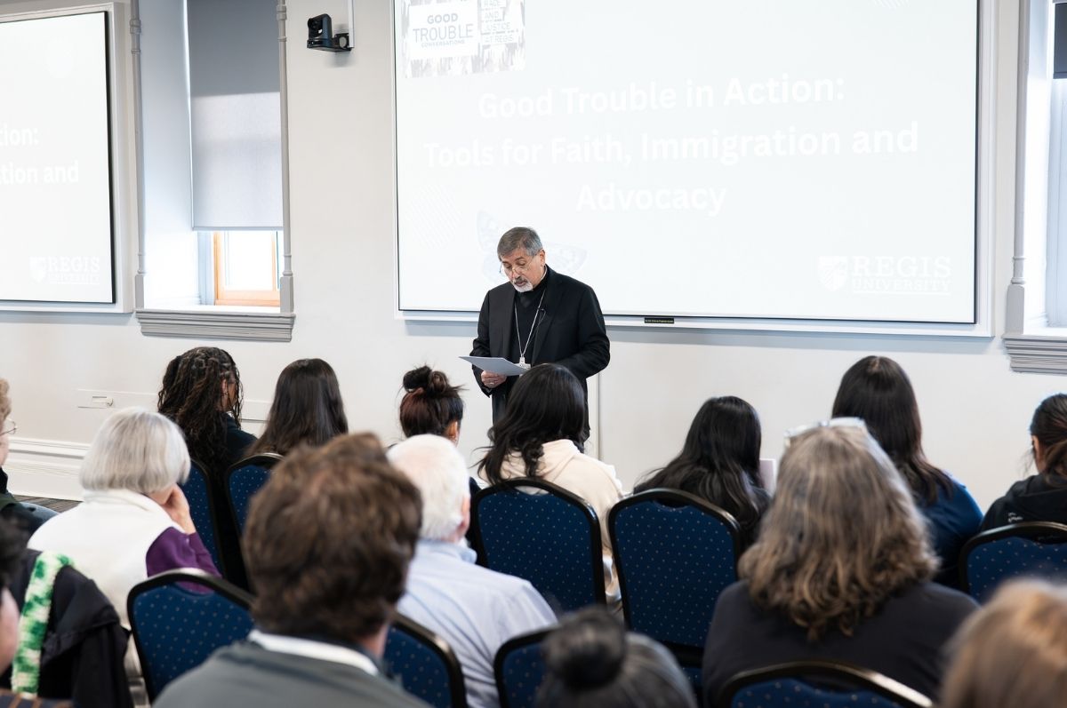Bishop Jorge Rodriguez speaking to a crowd at Regis University