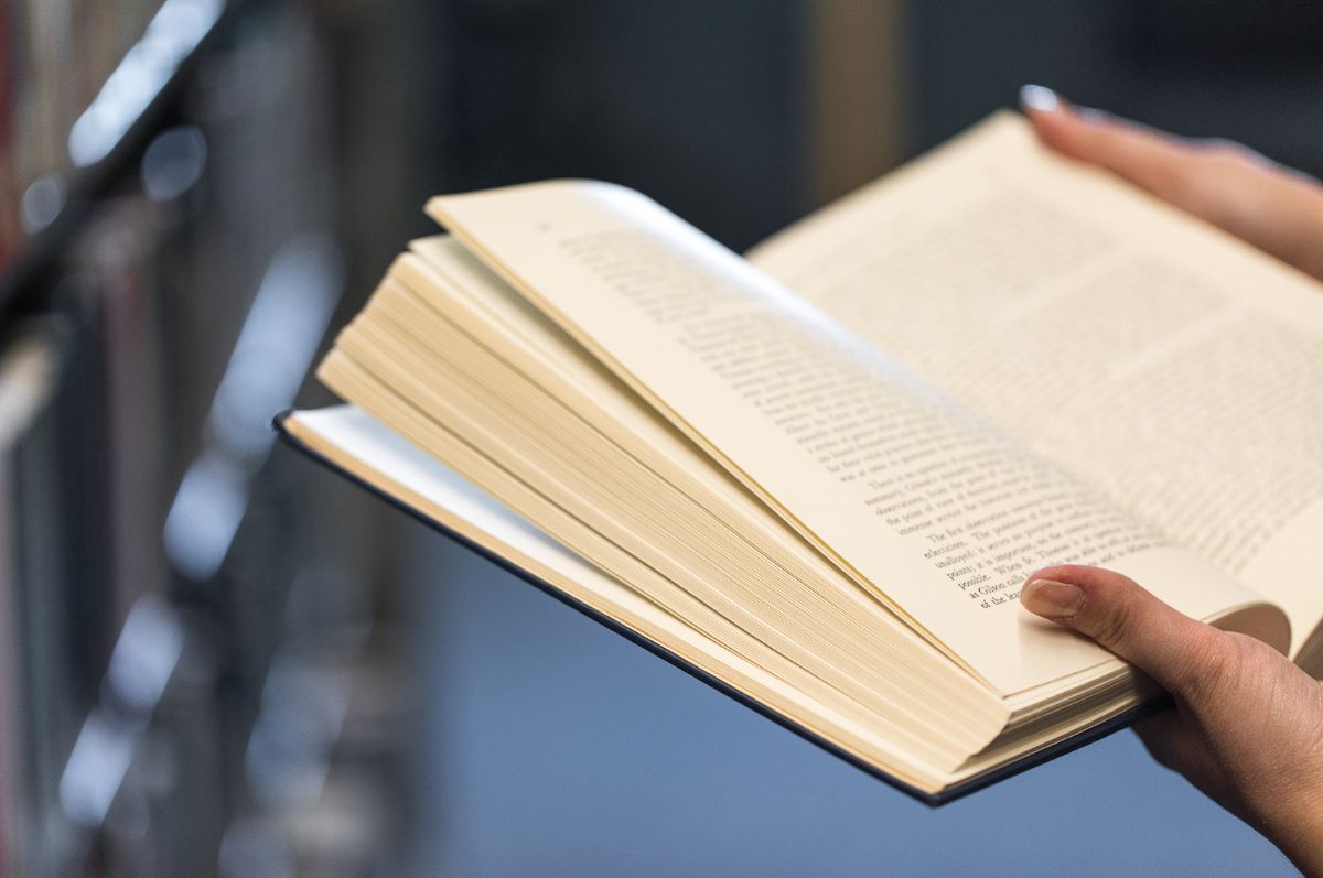 hands holding an open book