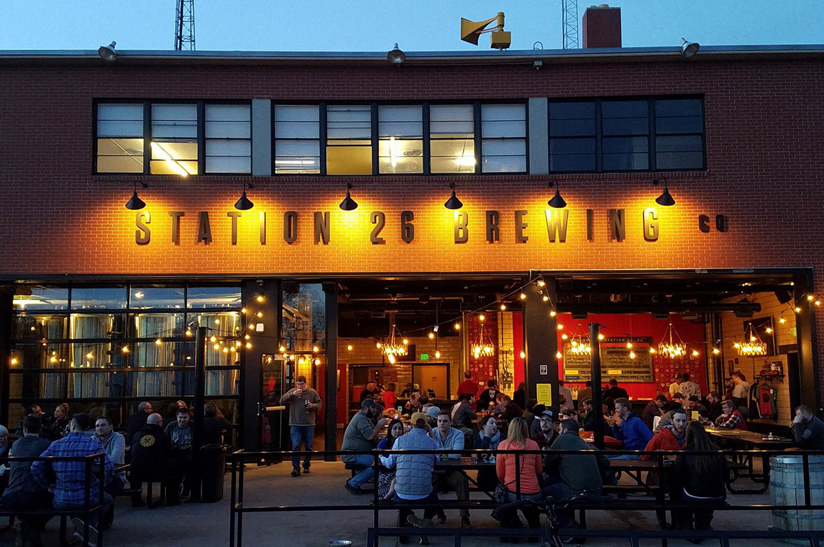 Patrons of Station 26 sit outside on a patio