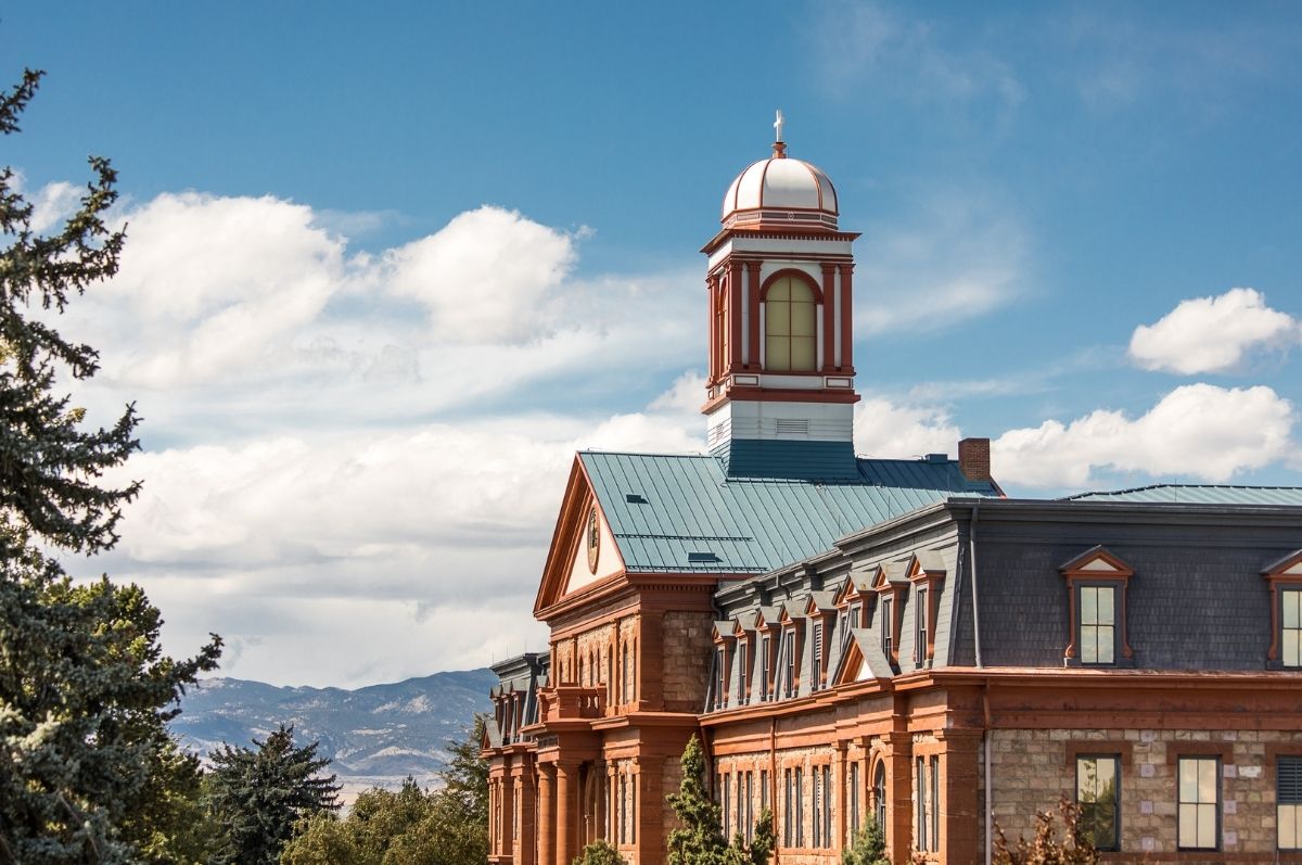 Regis University Main Hall with mountains in background