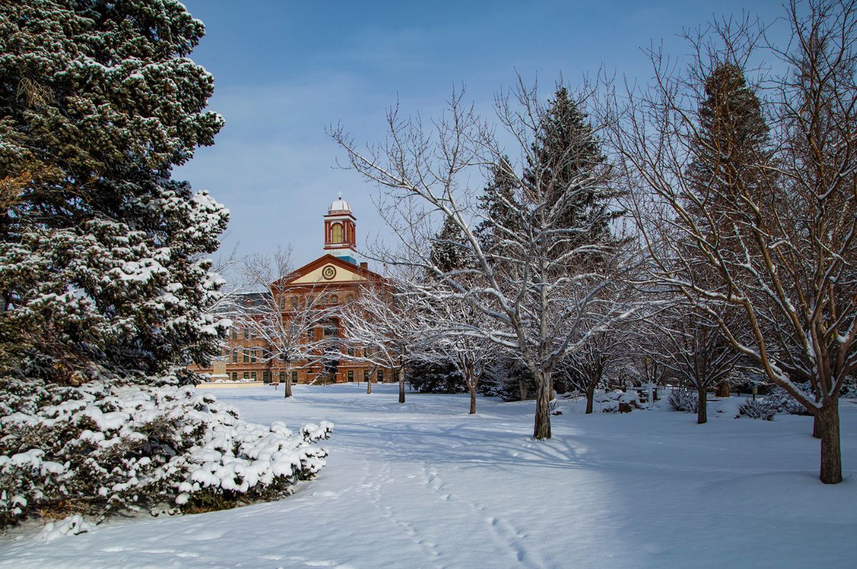 a view of Main Hall and Boettcher Commons blanked in snow on the Northwest Denver Campus