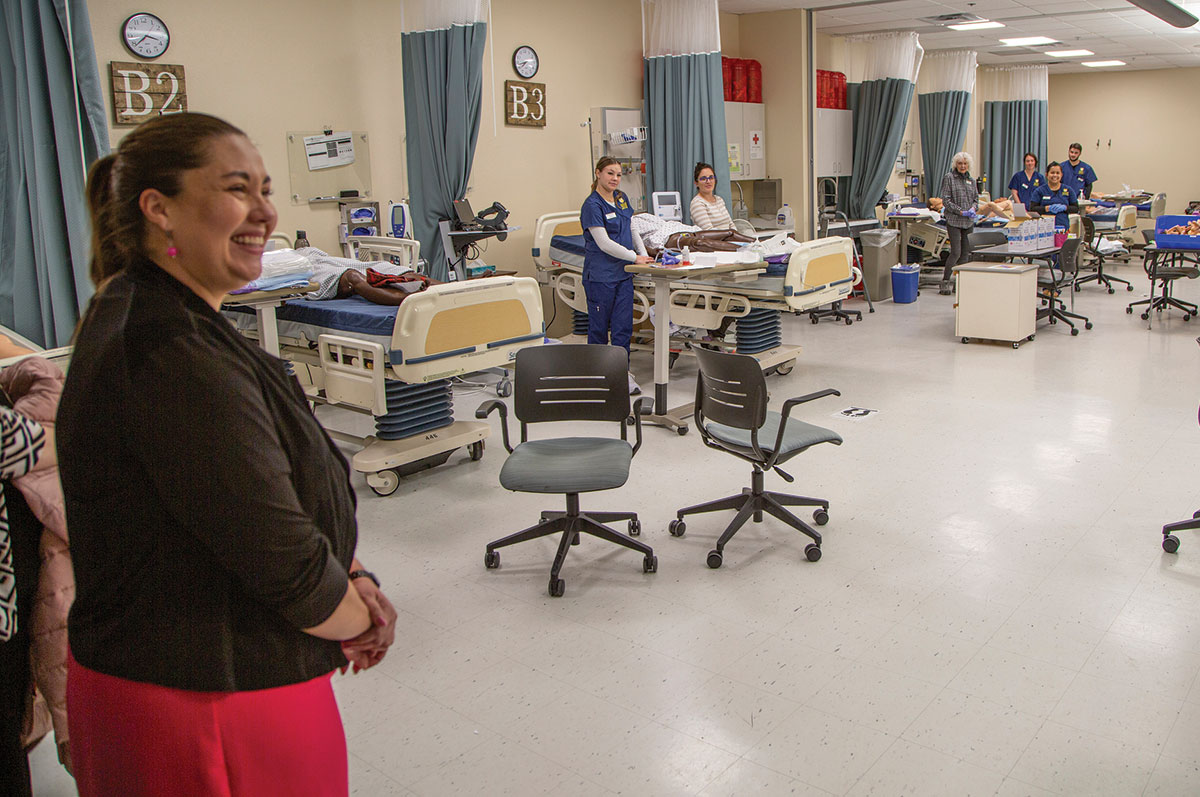 Yadira Caraveo observes student and staff in the health care simulation lab during her visit to Regis