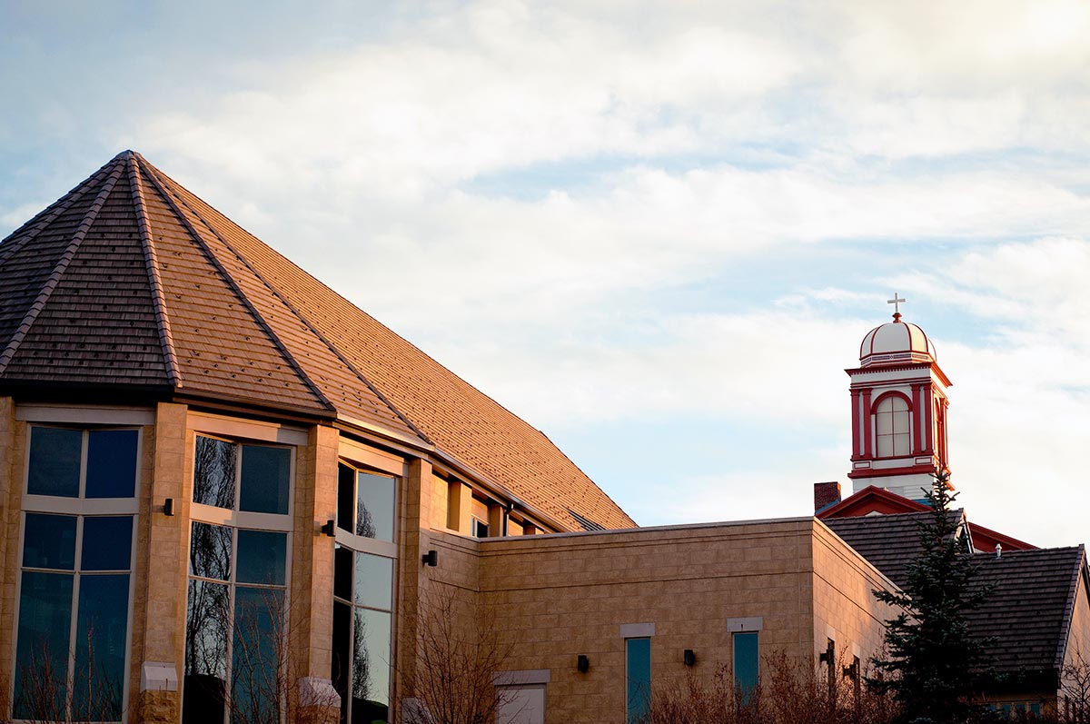 historic cupola of Main hall viewed over the roof of the St. John Francis Regis Chapel on the Northwest Denver Campus