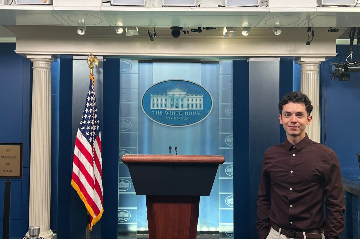 Christian Munoz stands in front of White House press podium