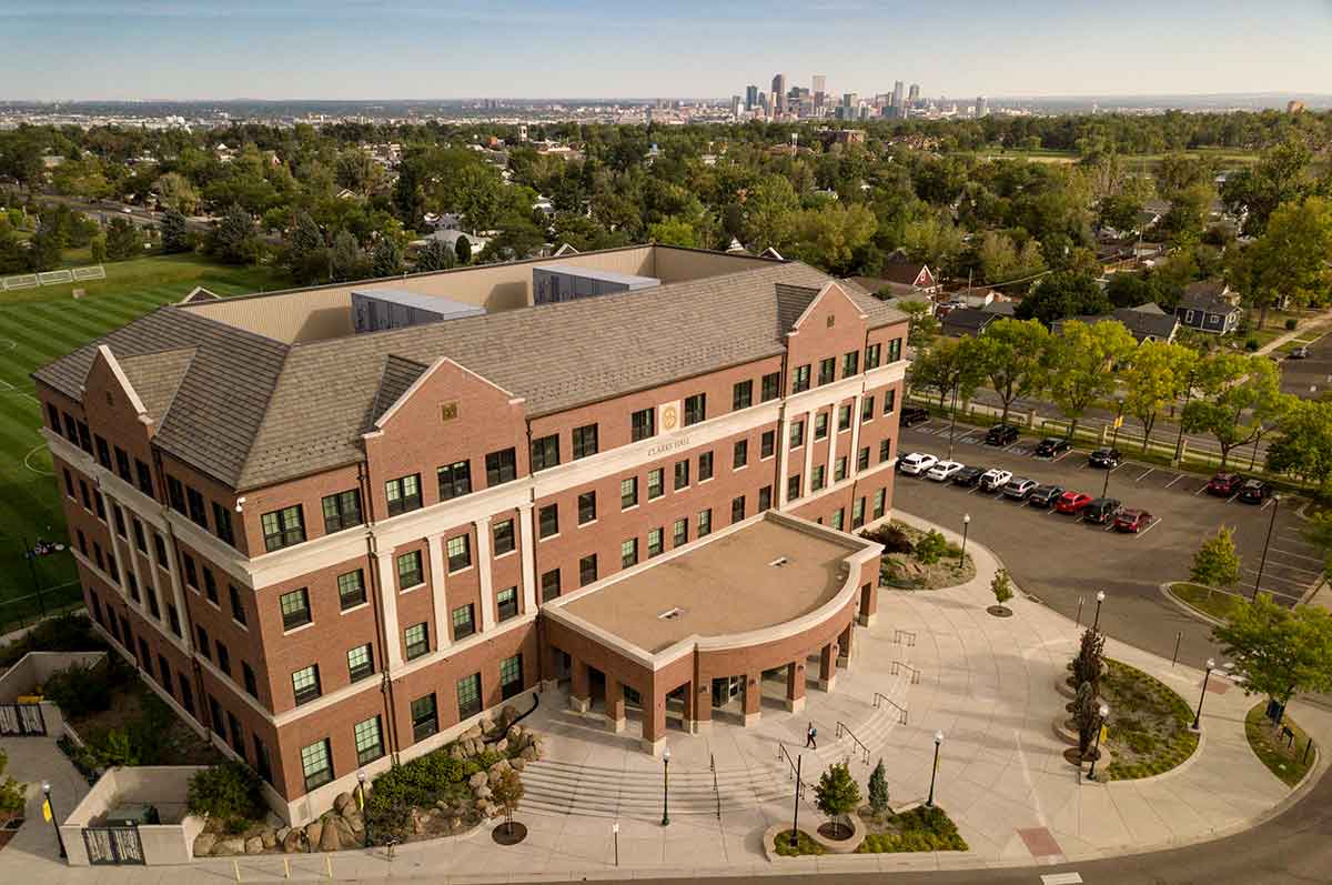 Aerial picture of David Clarke Hall, Denver skyline in the background