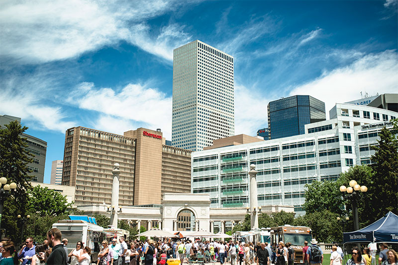 a culture fair in downtown Denver, featuring booths and food trucks in the Colorado sunshine