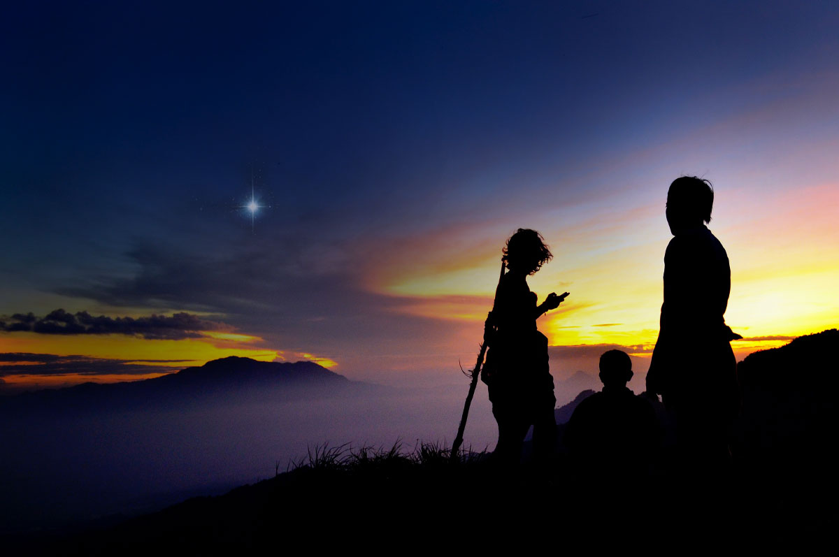composite image of a family hiking in the evening with a star shining in the twilight sky