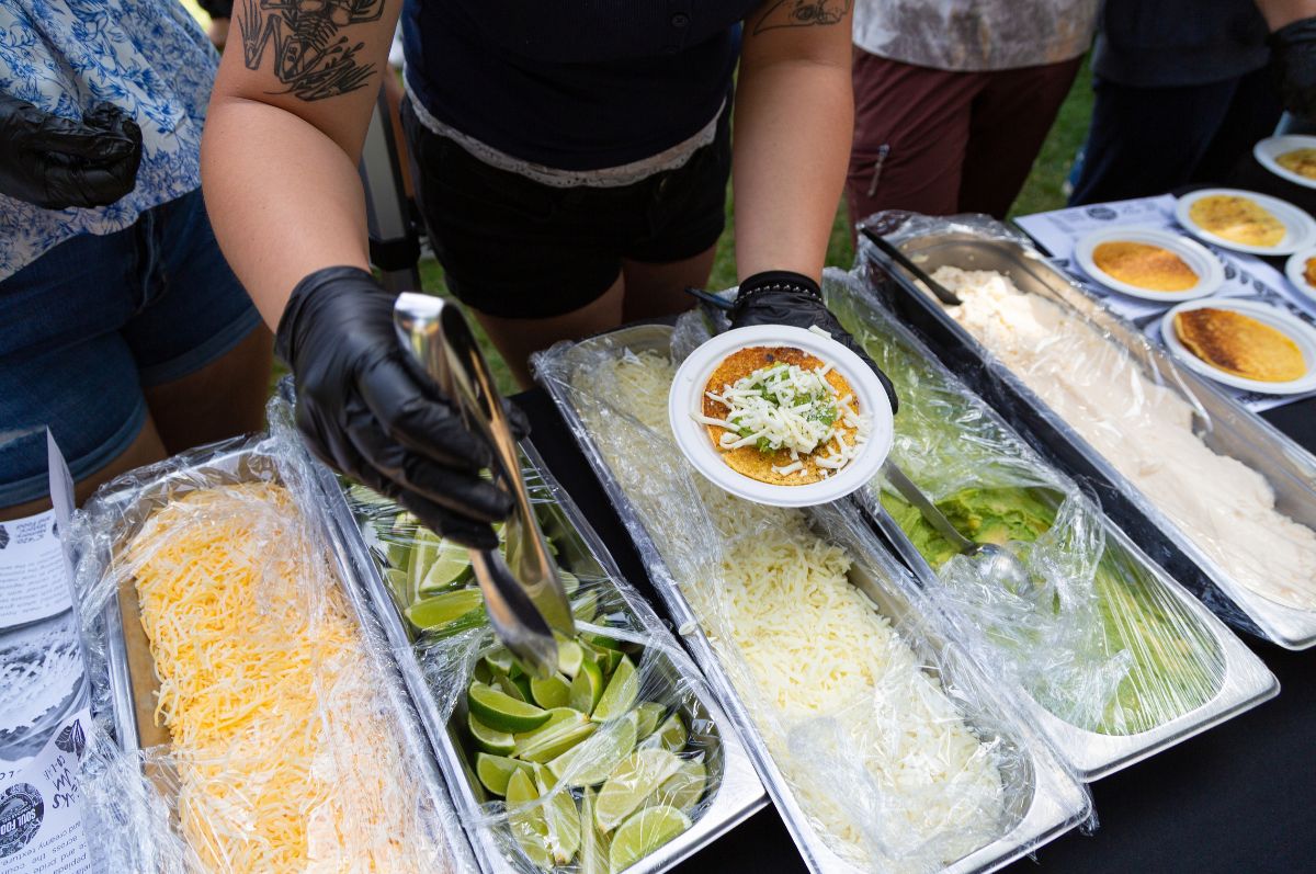 Student serving an arepa on the Quad 
