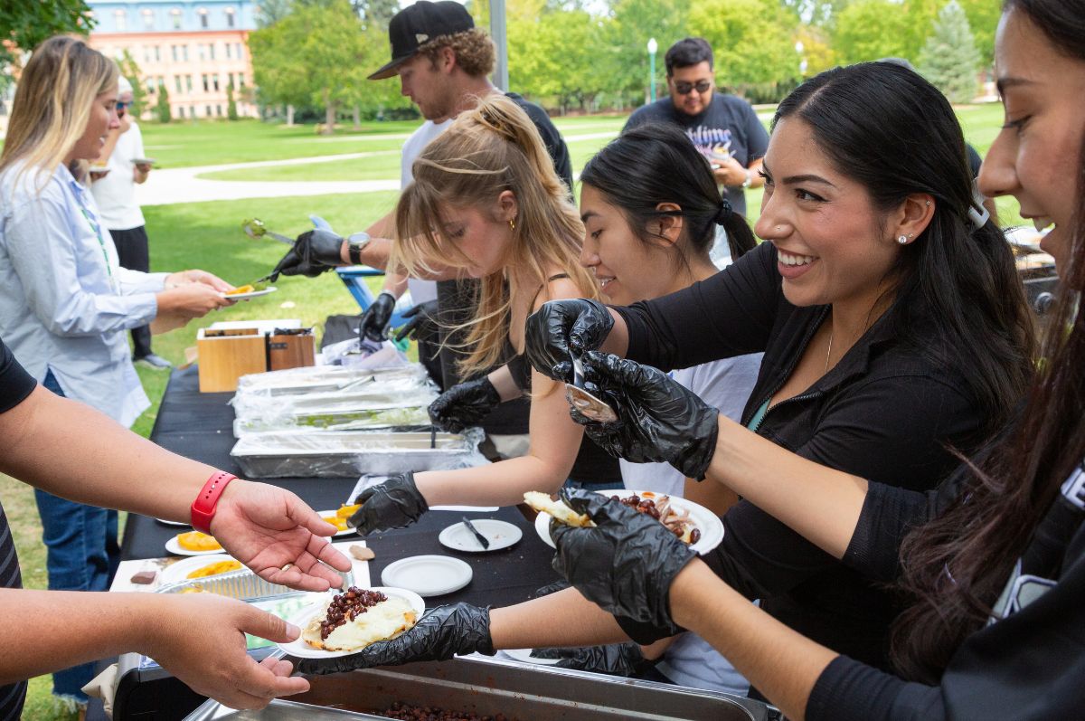 Student serving arepas on the Quad