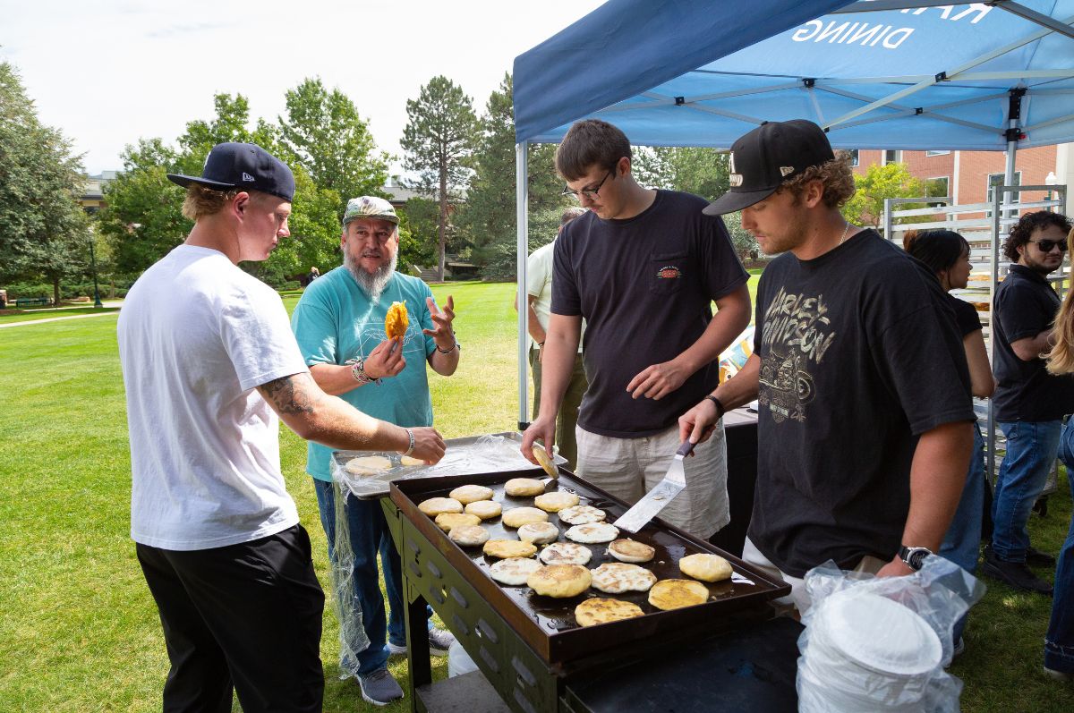 Students serving arepas on the Quad