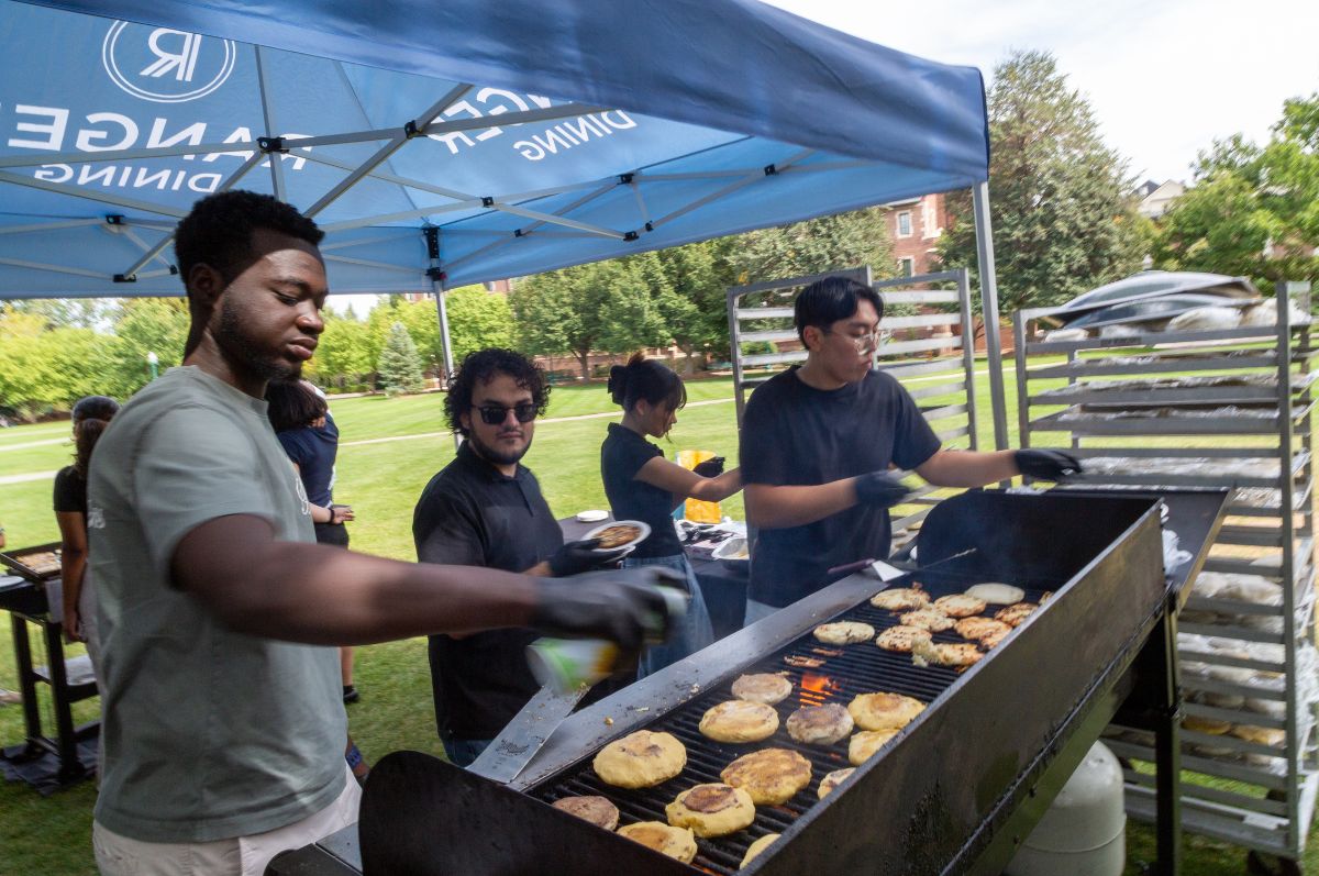 Student cooking arepas on the Quad