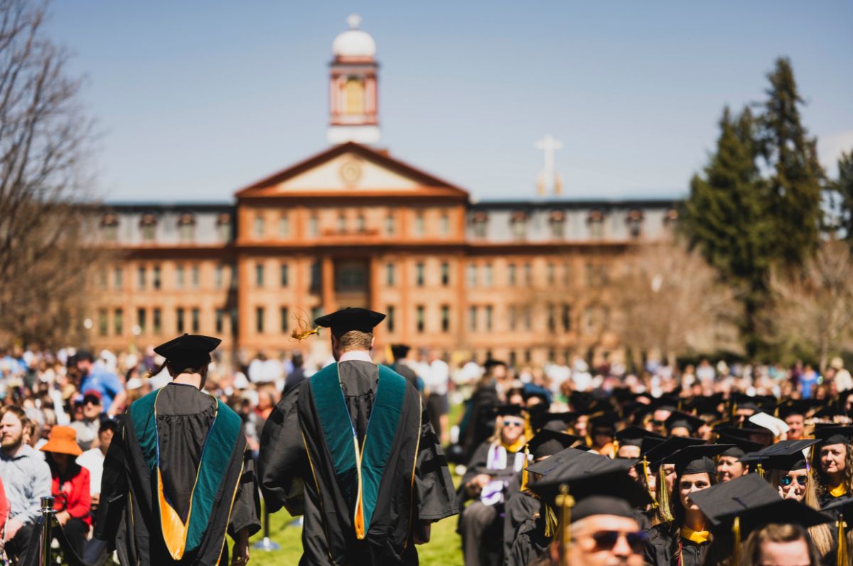 graduates walk on the quad during commencement