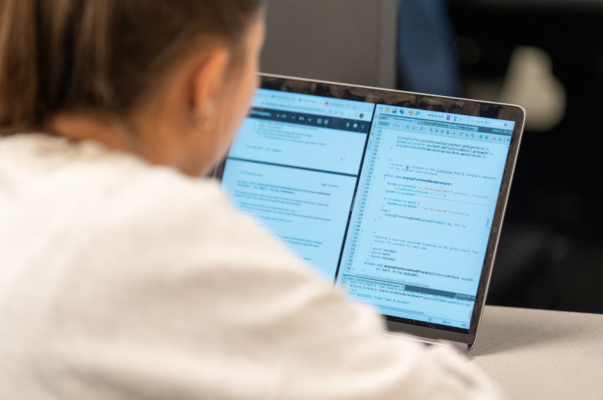 Student working on computer science work in a classroom