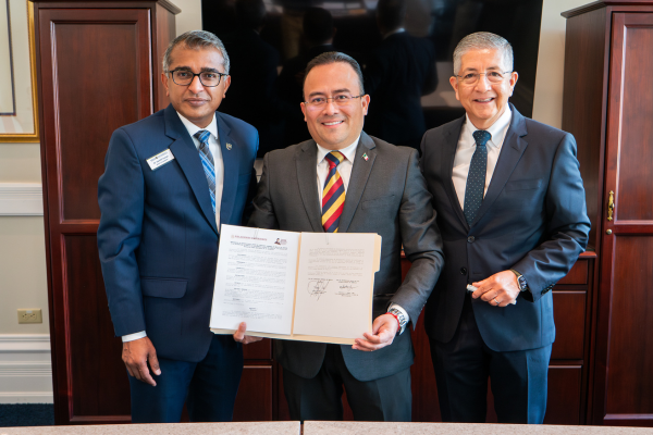 Regis leadership and consul of Mexico hold a signed document
