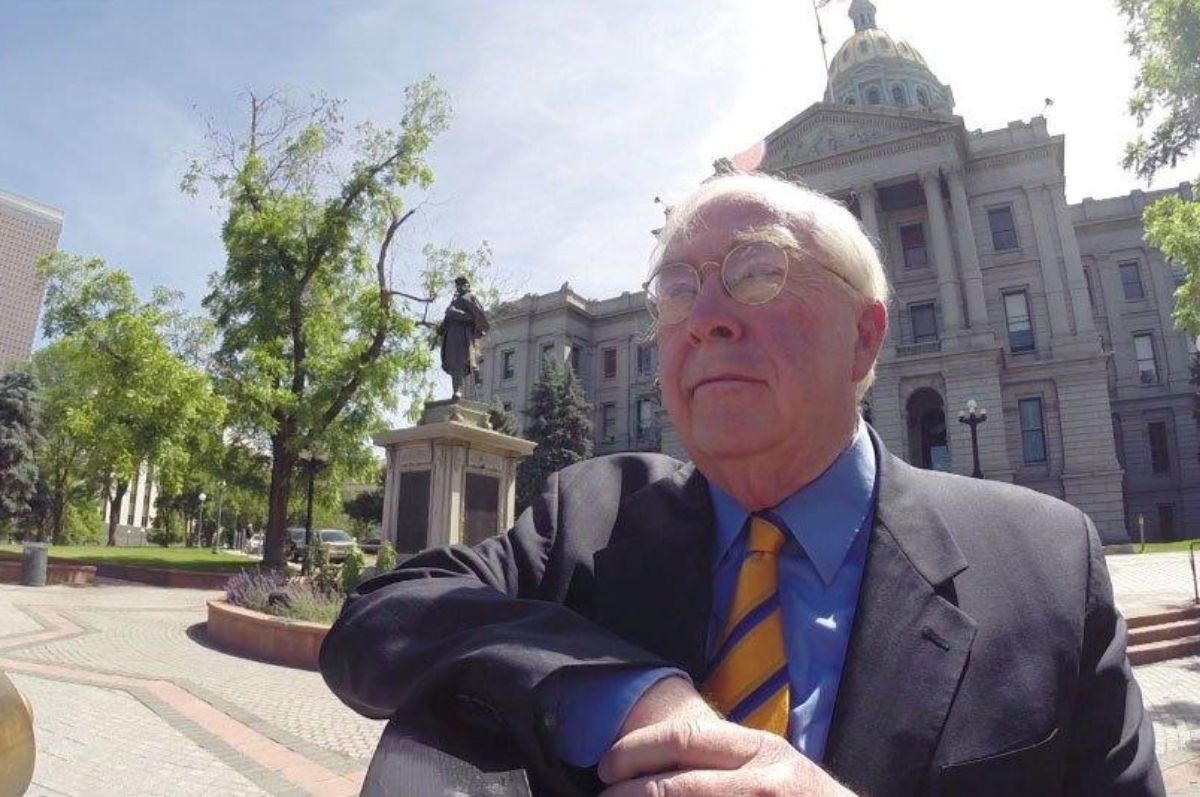 man stands in front of state capitol