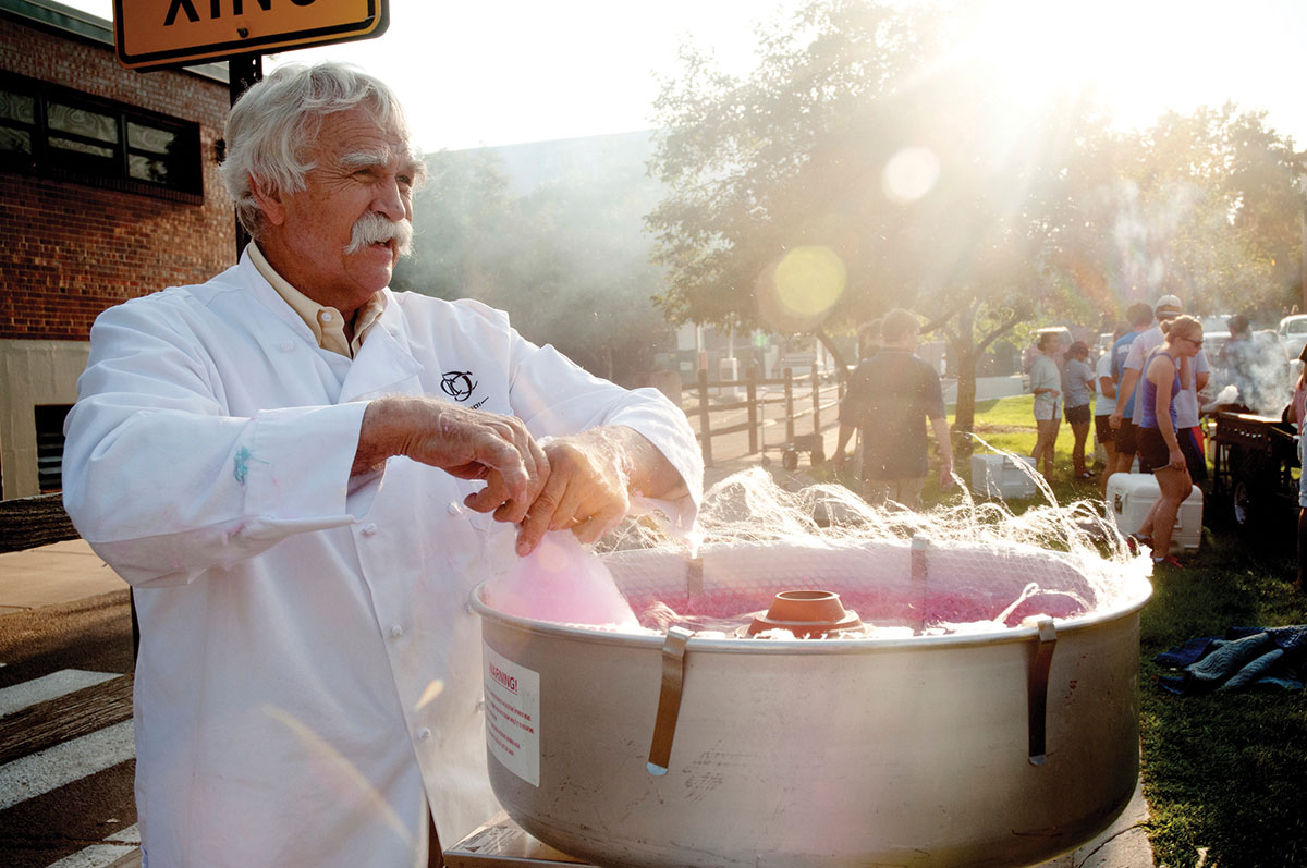 Don Lindley makes cotton candy in his cotton candy machine during an event on Regis’ Northwest Denver campus.