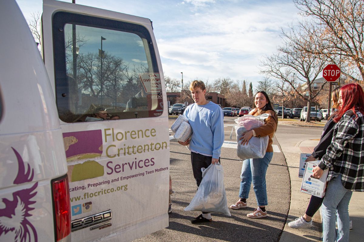 students load donations into van