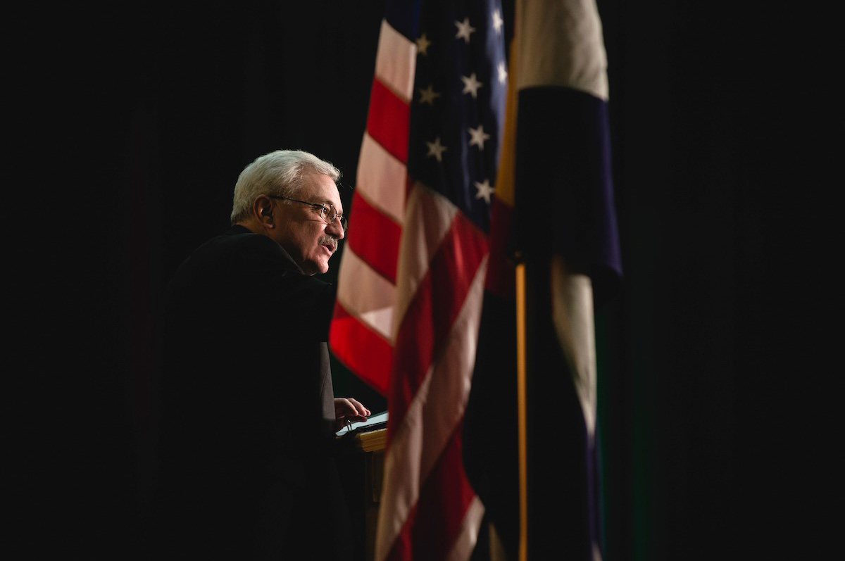 Regis University President, Rev. John P. Fitzgibbons, S.J., speaks at a podium