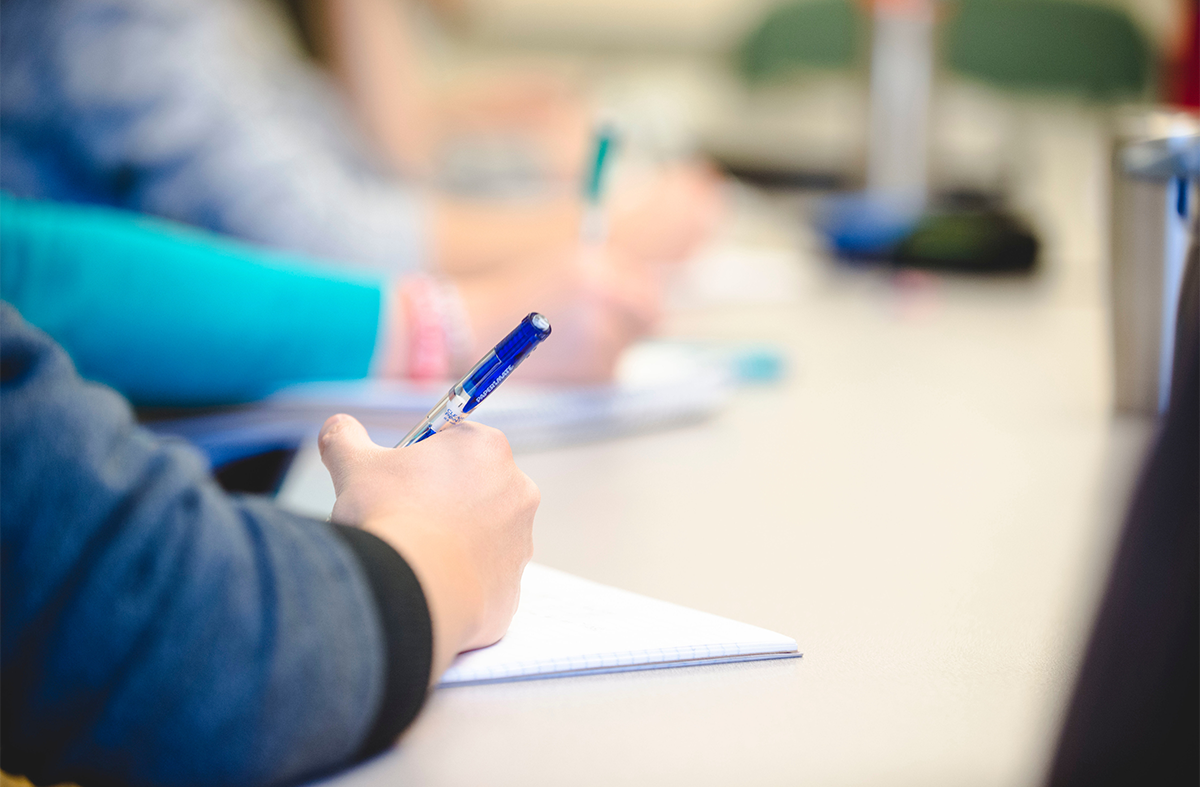 Regis University students work on coursework in a classroom