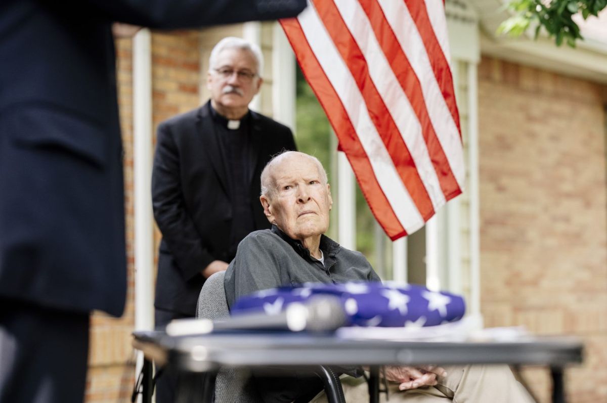  Fr. Flaherty listens to a ceremony