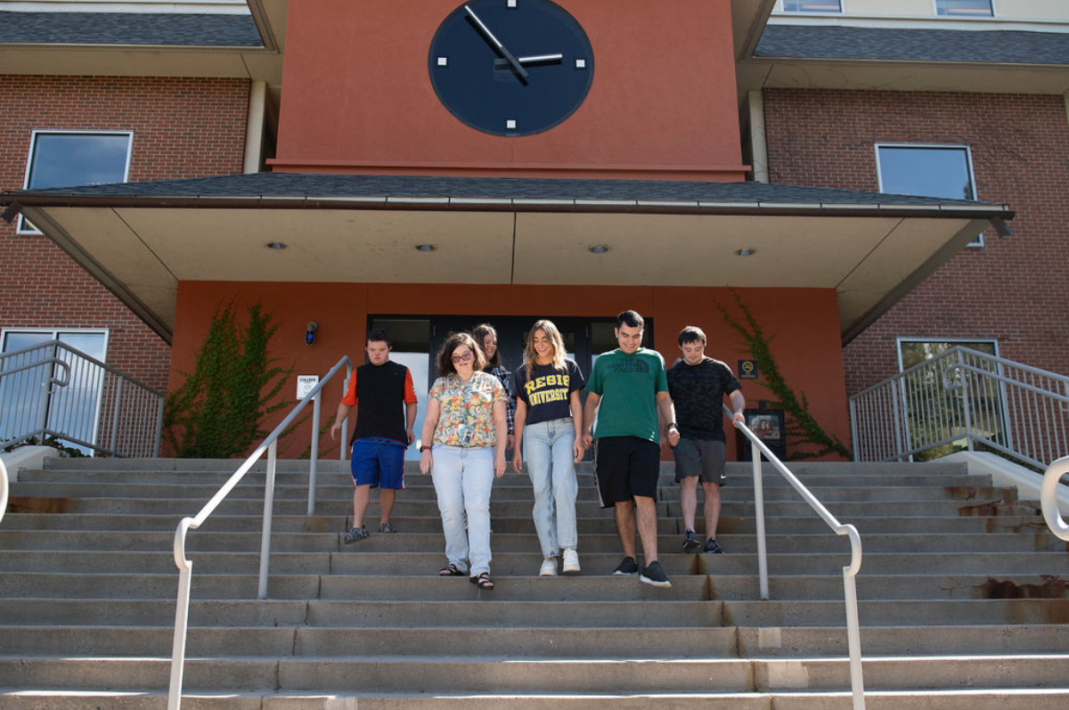 global students and peers walk down steps