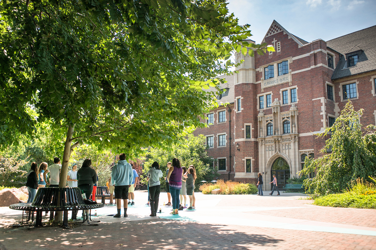 Regis University students stand as a group during fall orientation. 