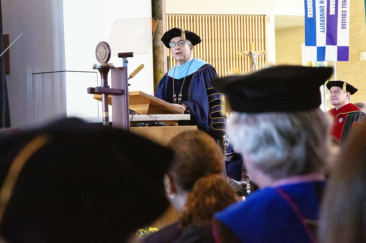 Salvador Aceves speaks in front of a large crowd at the inauguration ceremony in the Chapel