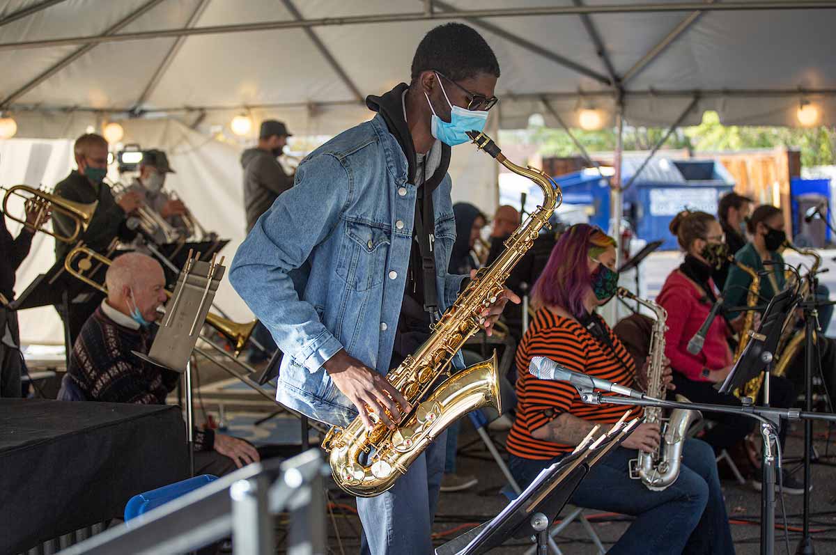 band performs under a tent