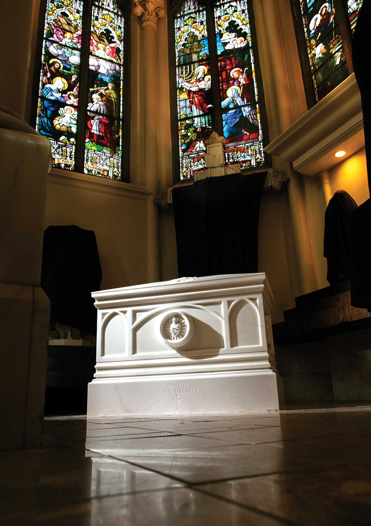 The marble coffin containing Greeley’s sits in the Cathedral Basilica of the Immaculate Conception surrounded by stained glass windows and draped statuary.