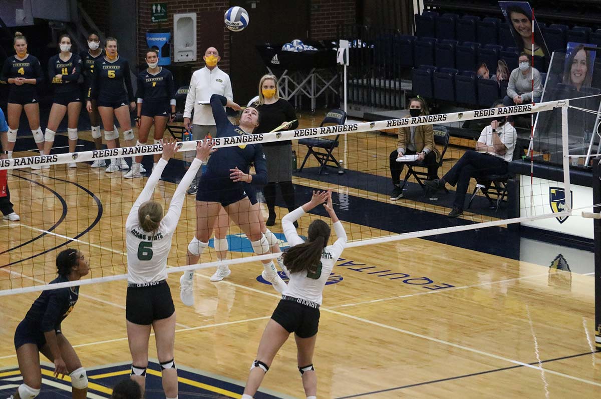 Regis Woman's Volleyball winning a match