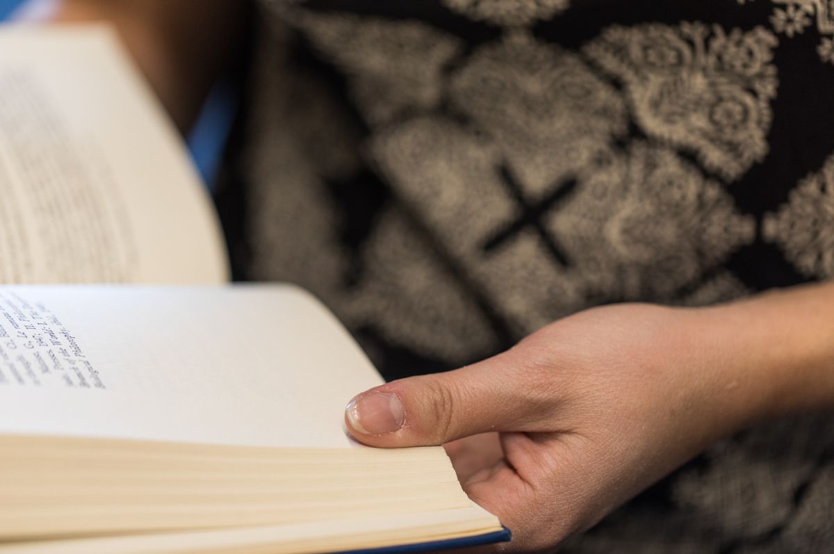 Student browsing library books in the Regis Library