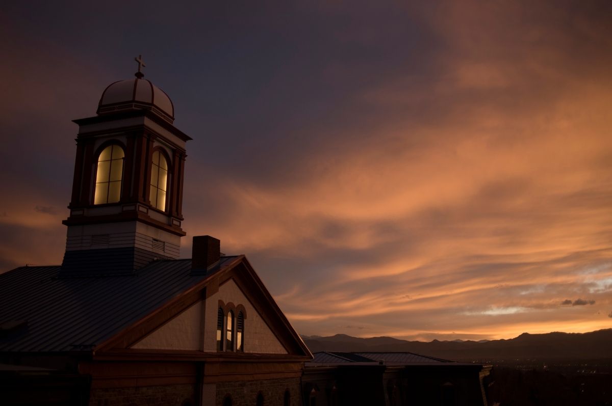 Main Hall at night with a sunset behind