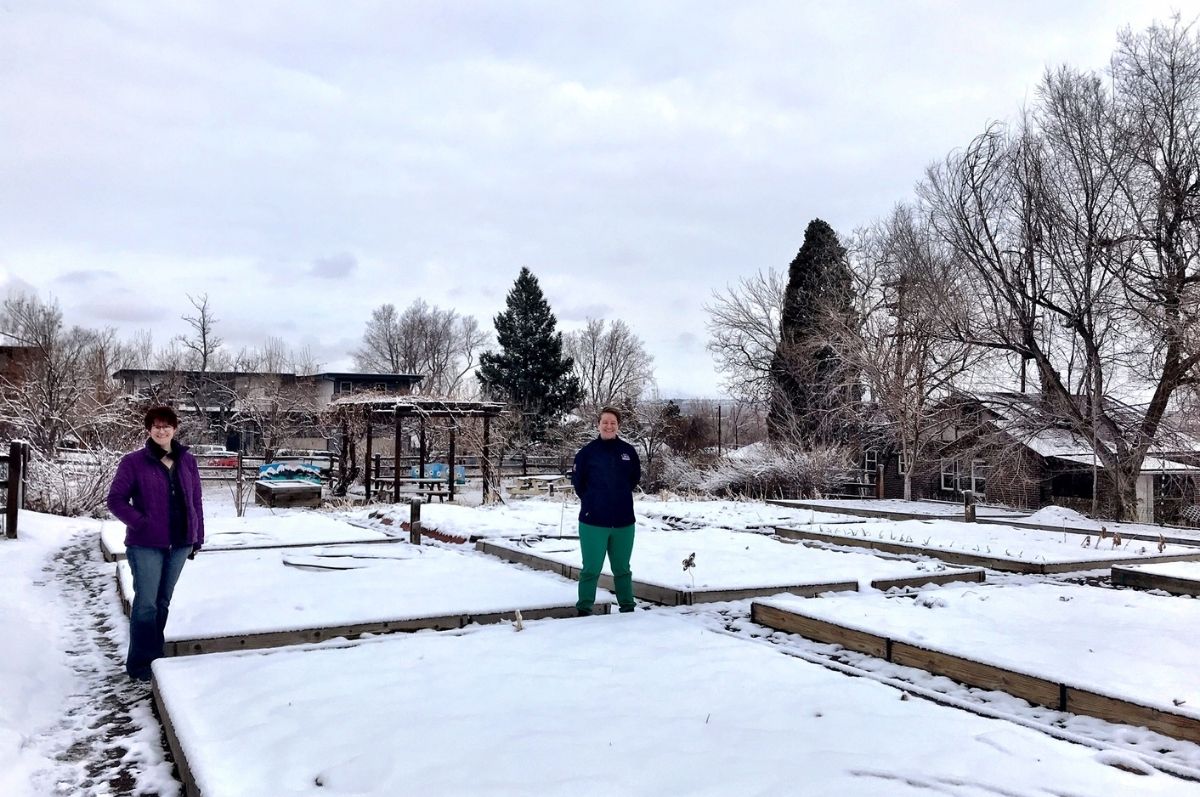 women standing in snowy garden