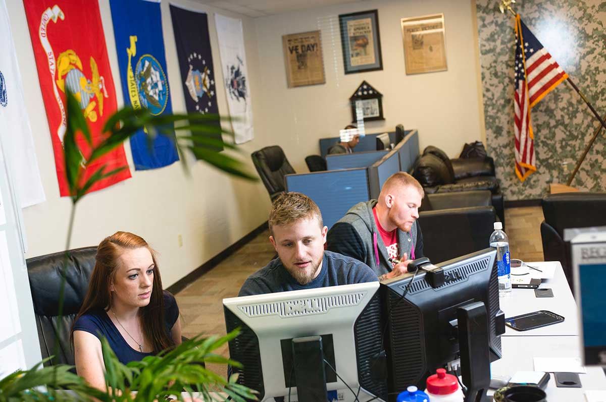 3 students work on computers in the veterans resource center on the Northwest Denver campus