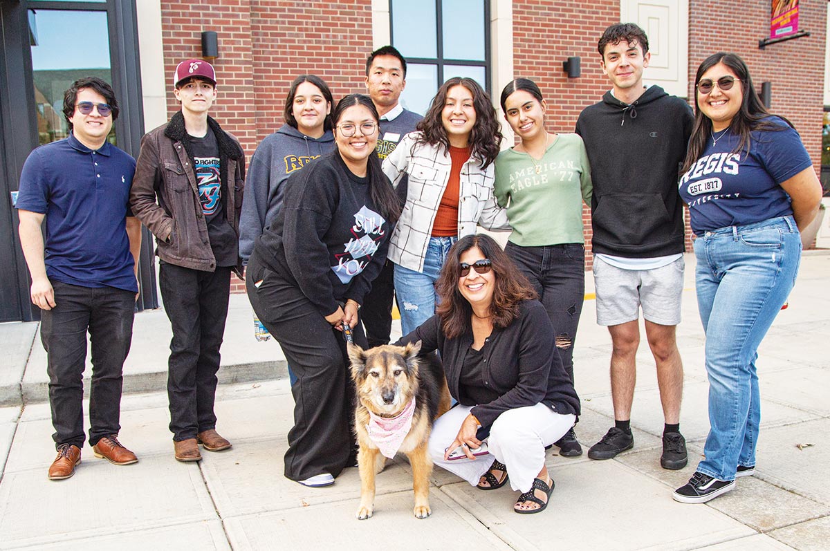 Vice Provost for Diversity and Inclusion Nicki Gonzales, with her dog, Rosie and a group of Regis students during the Blessing of the Pets ceremony this fall.