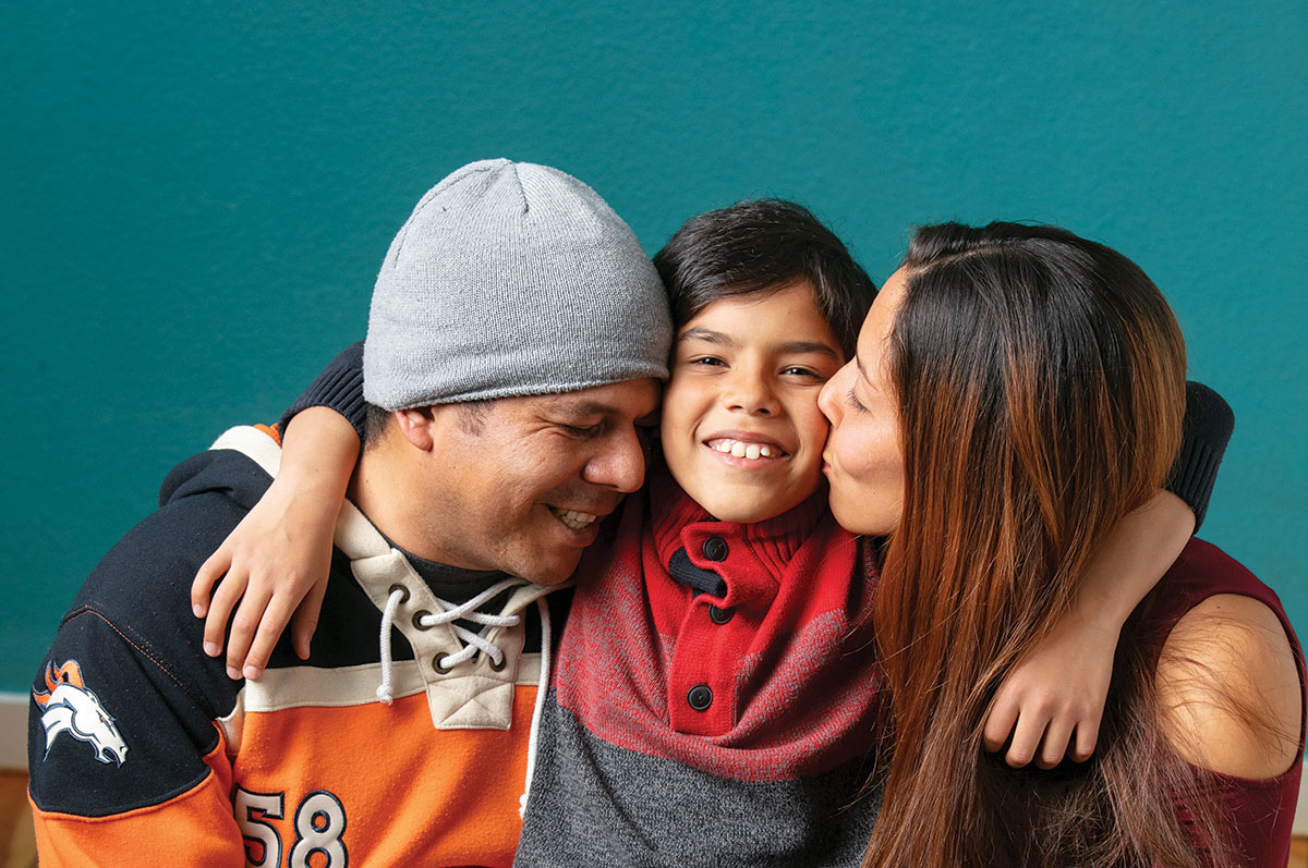 The Nunez-Pulgar family, Angelo, Meilyn and Alexander, embrace happily