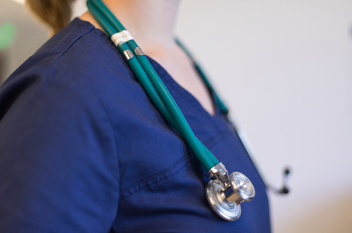 a nurse wears a stethoscope