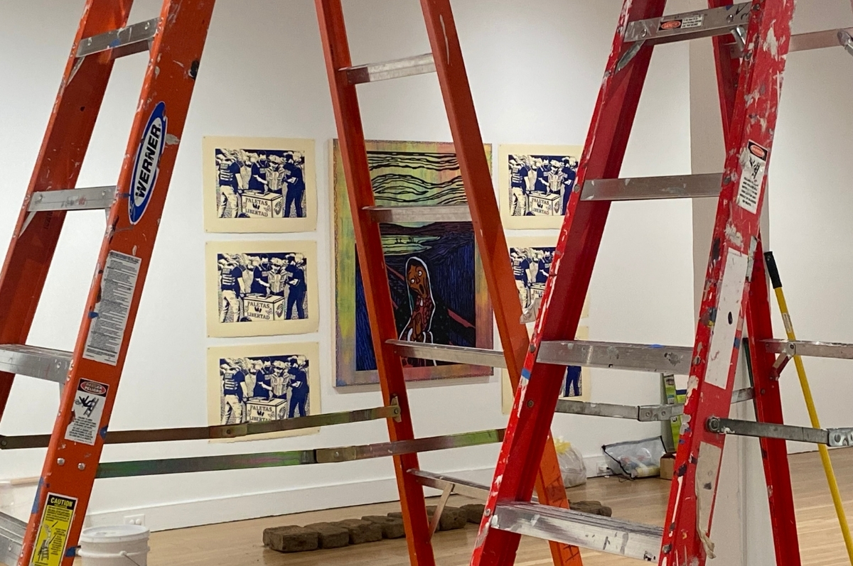Ladders and apintings during the installation process of the exhibition